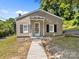 Charming single-story home boasts a welcoming front porch and sidewalk, enhancing curb appeal at 103 Garfield Ave, Albemarle, NC 28001