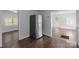 Kitchen with stainless refrigerator, connecting to living room and backyard entrance at 103 Garfield Ave, Albemarle, NC 28001