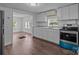 Well-lit kitchen showcasing stainless appliances and an open layout to living room at 103 Garfield Ave, Albemarle, NC 28001