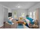 Staged living room featuring neutral furniture, a colorful rug, and plenty of natural light at 103 Garfield Ave, Albemarle, NC 28001