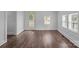 Bright living room featuring wood-look floors, white walls and a glass panel door at 103 Garfield Ave, Albemarle, NC 28001