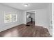 Bright living room featuring hardwood floors and white walls leading to the kitchen at 103 Garfield Ave, Albemarle, NC 28001