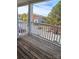 A cozy balcony with white wood railings and view of parking and foliage at 1104 Plaza Walk Dr, Charlotte, NC 28215