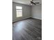 Bedroom with vinyl floors and ceiling fan with light fixture at 1104 Plaza Walk Dr, Charlotte, NC 28215