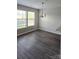 Inviting dining room area bathed in natural light, hardwood floors, and a modern chandelier for elegant dinners at 1104 Plaza Walk Dr, Charlotte, NC 28215