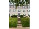 Inviting condo building entrance with lush greenery, enhancing the property's curb appeal and serene environment at 1104 Plaza Walk Dr, Charlotte, NC 28215