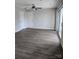 Expansive living room featuring dark hardwood floors, neutral paint, and access to a private balcony for outdoor enjoyment at 1104 Plaza Walk Dr, Charlotte, NC 28215