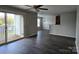 Bright living room with hardwood floors and sliding glass doors to the balcony, offering great natural light at 1104 Plaza Walk Dr, Charlotte, NC 28215