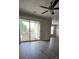 Bright living room with ceiling fan, hardwood floors and sliding glass doors to the balcony, offering great natural light at 1104 Plaza Walk Dr, Charlotte, NC 28215