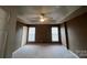 A bedroom featuring two windows, a ceiling fan, and neutral carpet at 12378 Swan Wings Pl, Huntersville, NC 28078