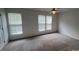 Spacious bedroom with plenty of natural light from large windows and neutral carpeting at 12378 Swan Wings Pl, Huntersville, NC 28078