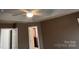 Bedroom featuring a closet with natural wood shelving and brown walls at 12378 Swan Wings Pl, Huntersville, NC 28078
