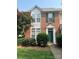 All brick townhome featuring green lawn and manicured front yard at 12378 Swan Wings Pl, Huntersville, NC 28078