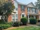 Charming brick townhome with well-maintained landscaping and inviting front entrance at 12378 Swan Wings Pl, Huntersville, NC 28078