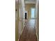 Hallway with wood flooring leads to a room with white fireplace at 12378 Swan Wings Pl, Huntersville, NC 28078