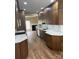 Well-lit kitchen featuring white countertops, stainless steel appliances, and wood flooring at 12378 Swan Wings Pl, Huntersville, NC 28078