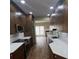 Spacious kitchen with modern appliances, white countertops, and brown cabinets at 12378 Swan Wings Pl, Huntersville, NC 28078