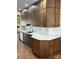 Kitchen showcasing modern, brown cabinets, white backsplash, stainless steel sink and countertops at 12378 Swan Wings Pl, Huntersville, NC 28078