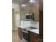 Kitchen showcasing modern, brown cabinets, white backsplash, stainless steel stove and countertops at 12378 Swan Wings Pl, Huntersville, NC 28078