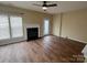 Spacious living room features a fireplace, ceiling fan and wood-look flooring at 12378 Swan Wings Pl, Huntersville, NC 28078