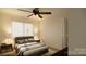 This bedroom features a ceiling fan, a window with blinds, and two lamps on either side of the bed at 1238 Carl Allen Rd, Edgemoor, SC 29712