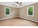 Bright bedroom features hardwood floors, a ceiling fan, and natural light from the two large windows at 1238 Carl Allen Rd, Edgemoor, SC 29712
