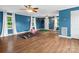 Spacious bonus room features hardwood floors, and natural light from the multiple windows with white curtains at 1238 Carl Allen Rd, Edgemoor, SC 29712