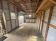 An empty garage features a roll-up door and wooden framing, offering a versatile space for storage and projects at 1238 Carl Allen Rd, Edgemoor, SC 29712