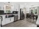 Modern kitchen with stainless steel appliances, white cabinetry, and a view of the dining area at 1238 Carl Allen Rd, Edgemoor, SC 29712