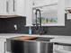 Close-up of a stylish kitchen sink with modern fixtures and a view from the kitchen window at 1238 Carl Allen Rd, Edgemoor, SC 29712
