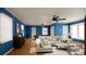 Living room with hardwood floors, a ceiling fan, a cream-colored couch, and two large windows at 1238 Carl Allen Rd, Edgemoor, SC 29712