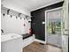 Mud room with a bench seat, a sink, white and black walls, and a door leading to the backyard at 1238 Carl Allen Rd, Edgemoor, SC 29712