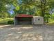 Spacious metal shed with a gravel driveway, perfect for storage or workshop at 1238 Carl Allen Rd, Edgemoor, SC 29712