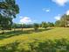 Lush grassy yard provides a tranquil outdoor setting with views of open fields at 1238 Carl Allen Rd, Edgemoor, SC 29712
