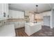 Modern kitchen with white cabinets, quartz countertops, island, and decorative backsplash at 129 John Smith Rd, York, SC 29745