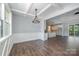 Elegant living room with hardwood floors, coffered ceiling, and open layout to the kitchen at 129 John Smith Rd, York, SC 29745