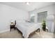 Bedroom with white comforter, wooden headboard, and lots of natural light at 1428 Winding Stream Rd, Charlotte, NC 28206