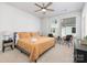 Bright bedroom with ceiling fan, neutral walls, and seating area by the window at 1428 Winding Stream Rd, Charlotte, NC 28206