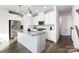 Stylish kitchen with stainless appliances, granite counters, central island, and white cabinets at 1428 Winding Stream Rd, Charlotte, NC 28206