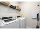 Convenient laundry room features washer, dryer, shelving, and ample storage space at 1428 Winding Stream Rd, Charlotte, NC 28206