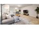 Living room with sectional sofa, patterned rug, bar, and television at 1428 Winding Stream Rd, Charlotte, NC 28206