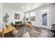 Sunlit living room showcasing modern decor, hardwood floors, and a welcoming atmosphere at 1428 Winding Stream Rd, Charlotte, NC 28206