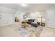 Living room featuring a gray sectional, patterned rug, and accent chair at 1428 Winding Stream Rd, Charlotte, NC 28206