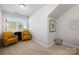 Small sitting area with two chairs and bright lighting at 1428 Winding Stream Rd, Charlotte, NC 28206