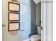 A powder room with a toilet, gray walls, and framed map art at 1549 Cottage Creek Dr, Bessemer City, NC 28016