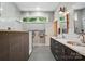 Modern bathroom featuring a double vanity, gray tile, and a large, glass-enclosed shower at 16525 Tulloch Rd, Charlotte, NC 28278