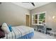 Bedroom showcases a cozy bed, sewing machine, and backyard view from the sunlit window at 16525 Tulloch Rd, Charlotte, NC 28278