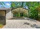 Open-air carport featuring a gravel floor and protective roof beside the primary structure and a privacy fence at 16525 Tulloch Rd, Charlotte, NC 28278