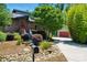 Brick home with a red door, lush landscaping, and an inviting walkway creating a warm welcome at 16525 Tulloch Rd, Charlotte, NC 28278