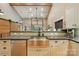Spacious kitchen with a large island, stainless steel sink, and bright white cabinetry at 16525 Tulloch Rd, Charlotte, NC 28278